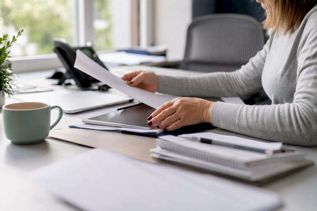 Centralized billing office workspace with devices and papers