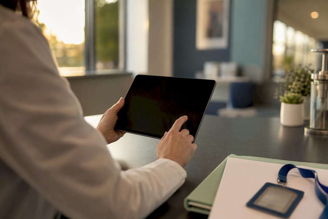 Hands verifying provider enrollment on tablet